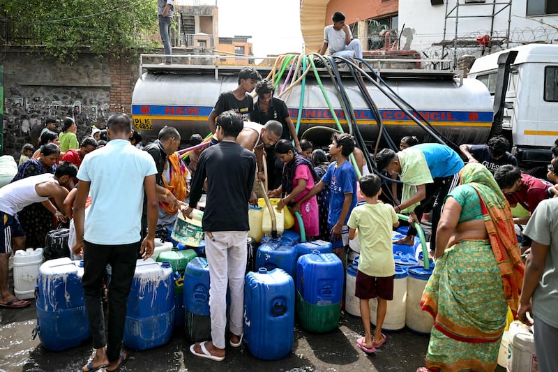 Residents fill containers with water from a municipal tanker in New Delhi amid a searing heatwave in the Indian capital. AFP