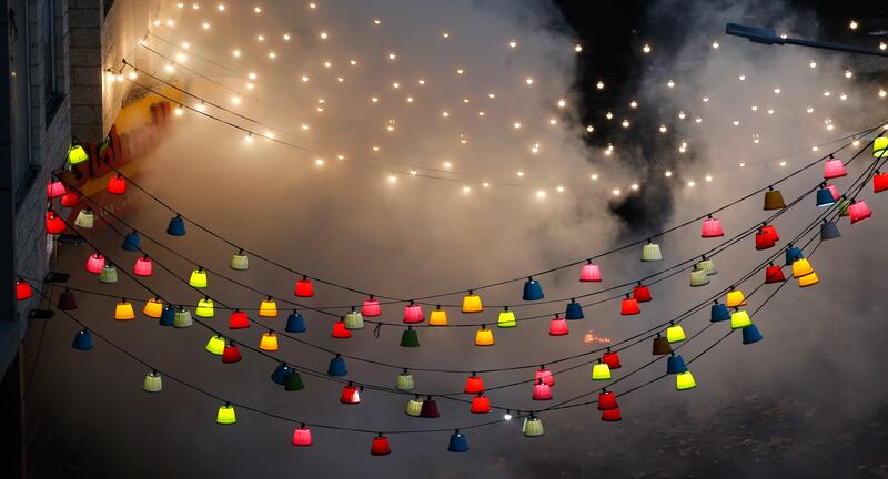Smoke rises above coloured lanterns. EPA