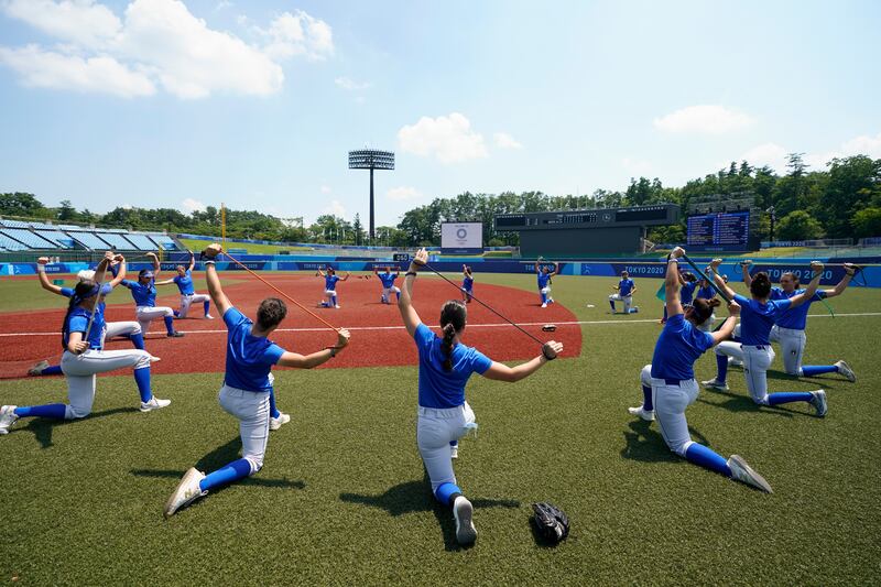 Members of the Italian women's softball team warm up during a training session at the Fukushima Azuma Baseball Stadium.