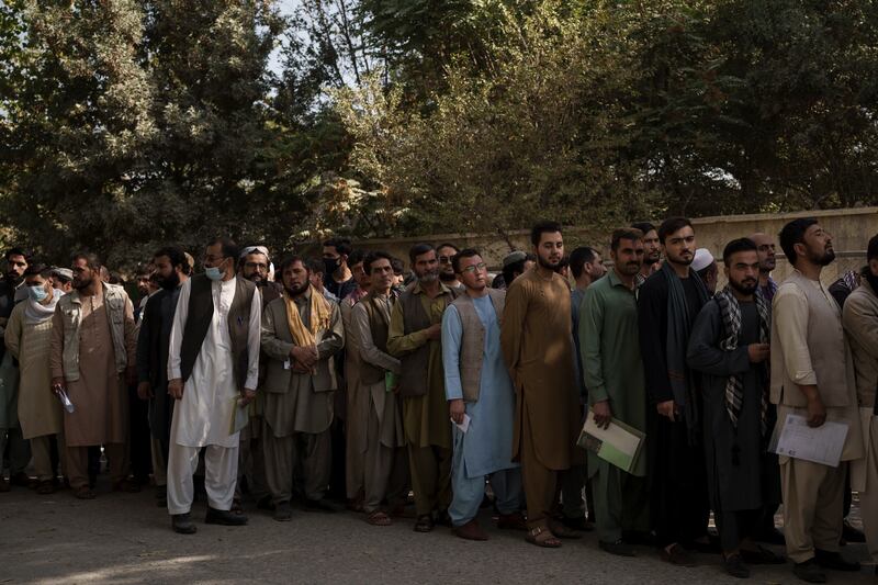 Afghans line up outside a government passport office recently re-opened by the Taliban. Photo: AP