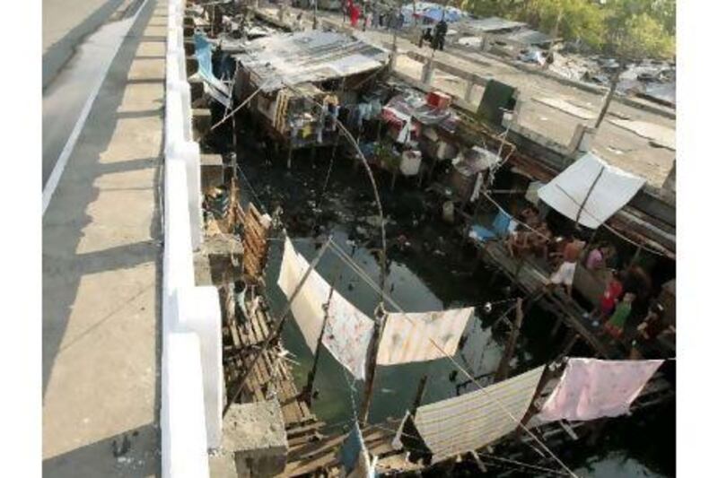 Filipinos in shantytowns like this benefit from conditional cash payments, a reader says. Francis R Malasig / EPA