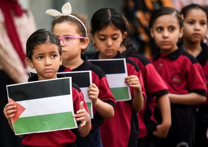 Pupils stand to mourn Palestinian children killed in Gaza, in Cairo, Egypt. Reuters