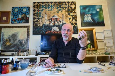 Turkey's micro artist Hasan Kale gestures as he speaks during an interview in Istanbul on August 23, 2019.  His canvas could be anything from match sticks, seeds to razors and crown corks. Turkey's micro artist, also known as Turkish Microangelo in reference to Italian Renaissance sculptor and painter Michelangelo, has been hitting his brush onto tiny everyday objects for more than two decades. - RESTRICTED TO EDITORIAL USE - MANDATORY MENTION OF THE ARTIST UPON PUBLICATION - TO ILLUSTRATE THE EVENT AS SPECIFIED IN THE CAPTION
 / AFP / Ozan KOSE / RESTRICTED TO EDITORIAL USE - MANDATORY MENTION OF THE ARTIST UPON PUBLICATION - TO ILLUSTRATE THE EVENT AS SPECIFIED IN THE CAPTION
