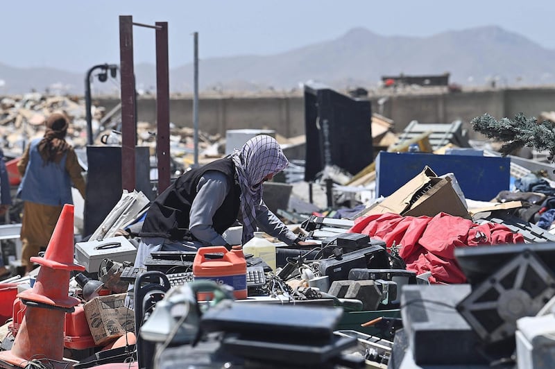 People look for useable items at a junkyard near the Bagram Air Base. AFP