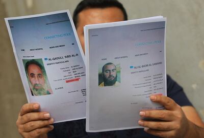 An Iraqi man holds printed profiles of Abu Bakr al-Baghdadi (R) an his deputy Abd al-Rahman al-Qaduli released by Iraq authorities on February 6, 2018.
Iraqi authorities issued a new list of "internationally wanted terrorists," headed by Islamic State group leader Abu Bakr al-Baghdadi.  / AFP PHOTO / AHMAD AL-RUBAYE