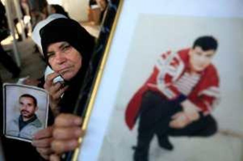 Palestinian families hold portraits of jailed relatives during a protest calling for their release from Israeli prisons on November 23, 2009 at the Red Cross offices in Gaza City. Israeli President Shimon Peres said there has been "progress" in talks to free soldier Gilad Shalit, held captive by Palestinian militants in the Gaza Strip for the past three years. AFP PHOTO/MOHAMMED ABED *** Local Caption ***  299599-01-08.jpg *** Local Caption ***  299599-01-08.jpg
