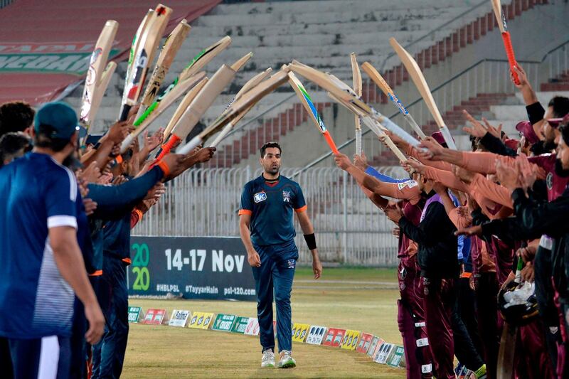 Teammates and opponents give a guard of honour to Pakistani cricketer Umar Gul during the National T20 Cup in Rawalpindi on  October 16, 2020. AFP