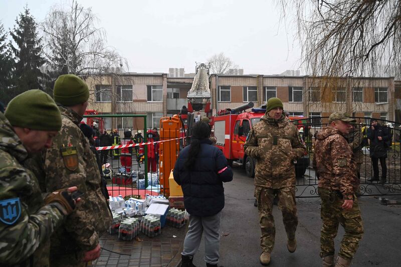 Military personnel and rescue workers near the crash site. AFP