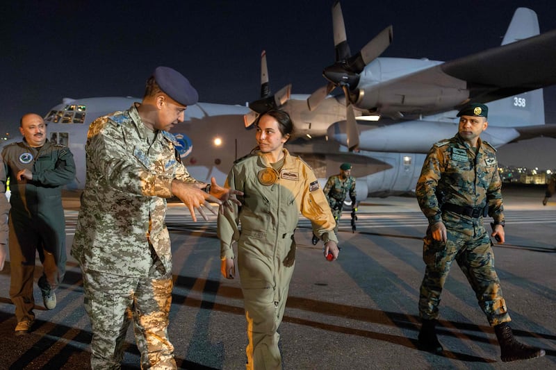 Princess Salma of Jordan, daughter of King Abdullah II and Queen Rania, is briefed by officers upon returning to Marka military airport. All photos: AFP