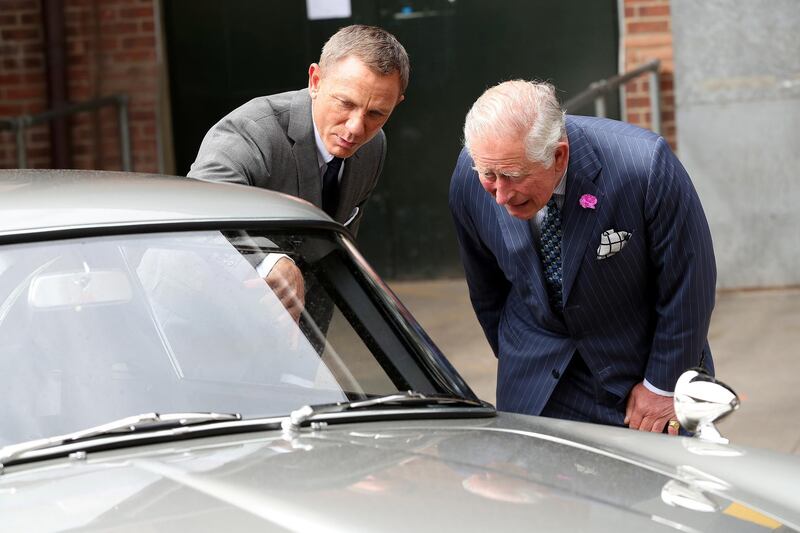 While on set, Prince Charles had a good look at the automotive props. Reuters