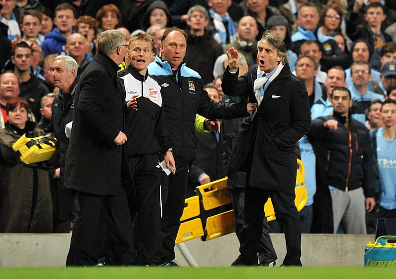 Manchester United's manager Sir Alex Ferguson and Manchester City's manager Roberto Mancini (right) confront each other on the touchline.