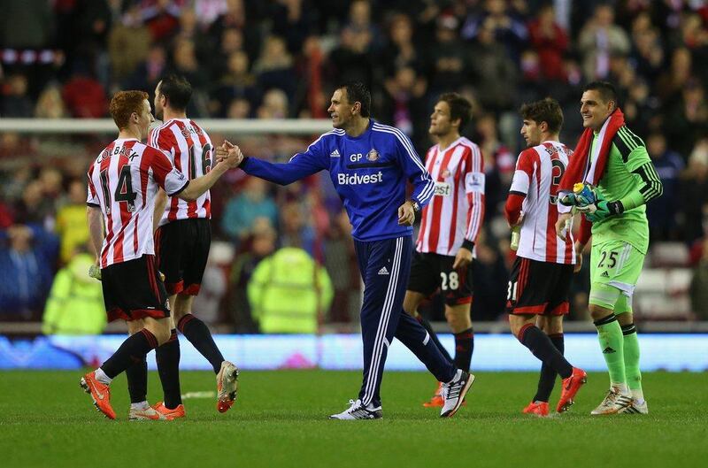 Sunderland manager Gus Poyet celebrates with Jack Colback and his players after avoided Premier League relegation on Wednesday with a win over West Bromwich Albion. Alex Livesey / Getty Images / May 7, 2014 