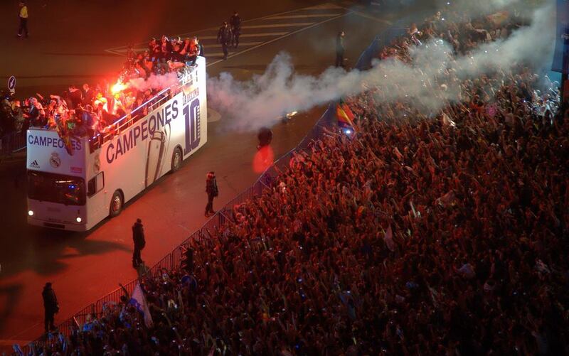 Real Madrid players on board the team bus celebrating the Champions League final victory with their fans at Cibeles Square in Madrid on Saturday night. Curto de la Torre / AFP / May 24, 2014