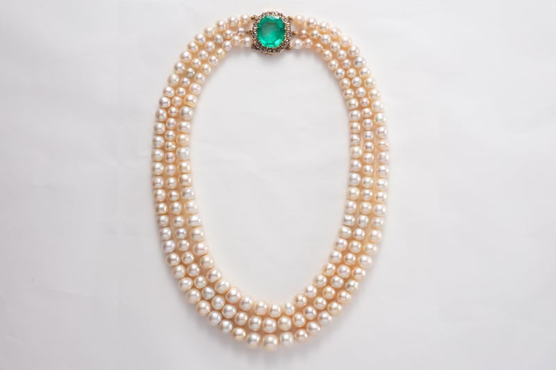 A Victorian three-strand pearl necklace with an emerald clasp