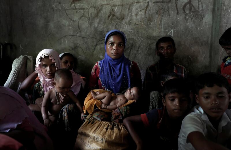 Newly arrived Rohingya refugee and mother of eight Shalida Begum, 25,  sits in a school room as the wait to be transferred to a camp in Cox's Bazar, Bangladesh, October 2, 2017. Begum said she travelled with her family through the forests of Myanmar for forty days after her house was burned by soldiers. REUTERS/Cathal McNaughton     TPX IMAGES OF THE DAY