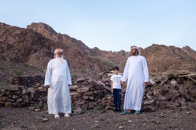 RAS AL KHAIMAH, UNITED ARAB EMIRATES - JANUARY 8, 2019. 

Obaid Saeed Obaid, with his grandson, Obaid, 7, and son, Saif, 39; in Wadi Kub.

(Photo by Reem Mohammed/The National)

Reporter: Ruba Haza
Section:  NA