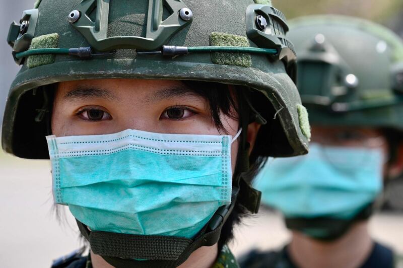 Soldiers wearing face masks amid the coronavirus pandemic stand in formation during Taiwan President Tsai Ing-wen's visit to a military base in Tainan, southern Taiwan.  AFP