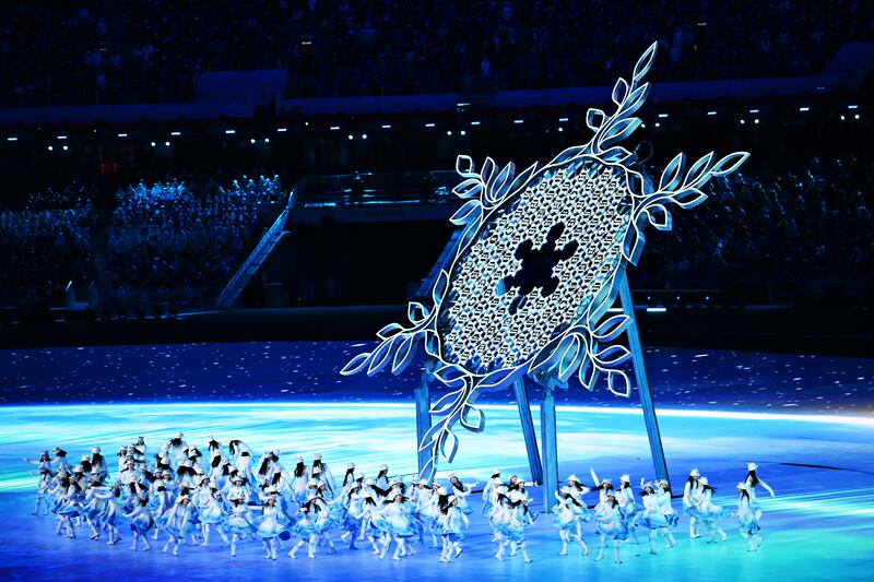 Dancers perform around the large snowflake during the opening ceremony. Getty
