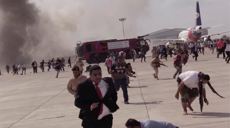 People run after an explosion at the airport in Aden, Yemen, shortly after a plane carrying the newly formed Cabinet landed. No one on board the government plane was hurt but initial reports said several people at the airport were killed.  AP