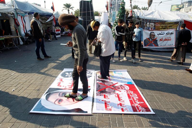 Iraqi demonstrators step on pictures of former Iraqi President Saddam Hussein, his daughter Raghad Saddam Hussein and former Iraqi Kurdistan region's President Masoud Barzani, during ongoing anti-government protests in Baghdad, Iraq. Reuters
