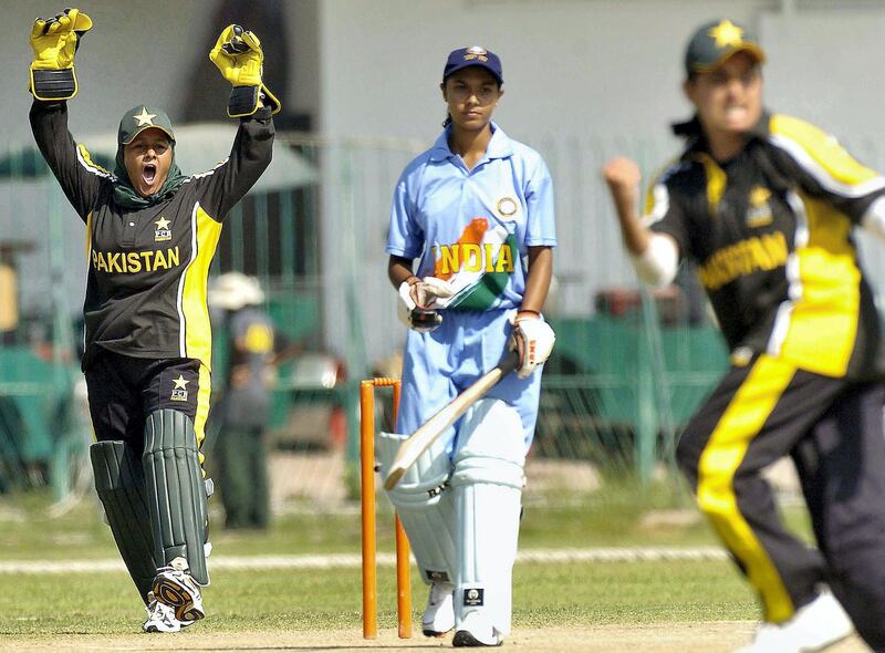 Pakistani under-21 women cricket team bowler Sana Mir (R) gestures after the dismissal of Indian batsman Sindhu Ashok (C) during the one day international (ODI) cricket match between Pakistan and India women's team at the Gaddafi Stadium in Lahore, 02 October 2005. Batting first India scored 215 runs in their alotted 40 overs.  AFP PHOTO/Arif ALI (Photo by Arif Ali / AFP)