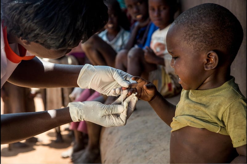 A health worker from Living Goods, one of the Zayed Sustainability Prize finalists, delivers medication to a child in Africa. The project manages 8,700 community health workers in Kenya and Uganda. Courtesy Zayed Sustainability Prize