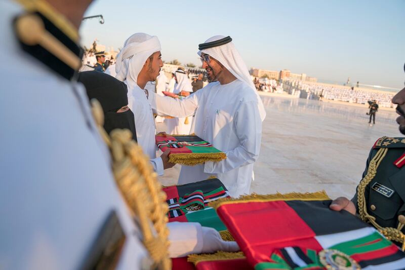 ABU DHABI, UNITED ARAB EMIRATES - November 30, 2017: HH Sheikh Mohamed bin Zayed Al Nahyan, Crown Prince of Abu Dhabi and Deputy Supreme Commander of the UAE Armed Forces (R), presents a medal to a family member of a martyr who passed within the past year. Seen during a Commemoration Day ceremony, at Wahat Al Karama.
( Mohamed Al Hammadi / Crown Prince Court - Abu Dhabi )
---