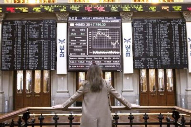 epa03013617 A woman looks at a screen that shows the index rise of the Spanish IBEX 35 at the Stock Market in Madrid, Spain, 24 November 2011. Banco de Valencia shares fell 20.27 per cent, a loss of 73 million euros, just as it returns back to the stock market after the Bank of Spain rescued the lender and replaced its managers and the bank held its shares out of the stockmarket 21 November 2011.  EPA/JUAN CARLOS HIDALGO *** Local Caption ***  03013617.jpg