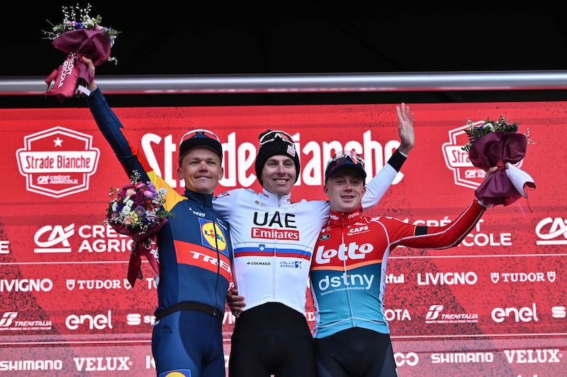 Race winner Tadej Pogacar, centre, with with second placed Tom Skujins, left, of Lidl-Trek, and Maxim Van Gils of Lotto Dstny. AFP