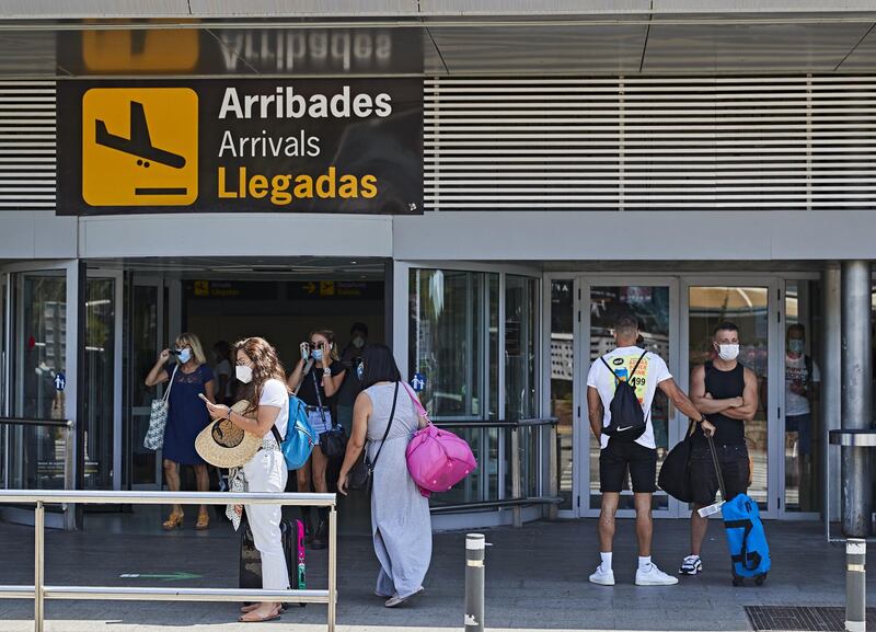 IBIZA, SPAIN - JULY 28: Newly arrived tourists in the area outside Ibiza airport on July 28, 2020 in Ibiza, Spain. The United Kingdom, whose citizens comprise the largest share of foreign tourists in Spain, added Ibiza and other Spanish islands to its advice against non-essential travel to the country, citing a rise in coronavirus cases. The change follows the UK's decision to reimpose a 14-day isolation period for travelers returning from Spain. (Photo by Andres Iglesias/Getty Images)