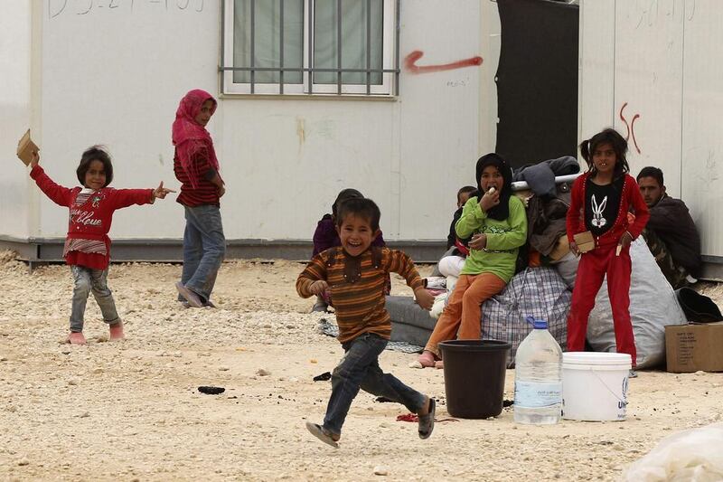 Syrian refugee children play at Zaatari refugee camp in the Jordanian city of Mafraq, near the border with Syria. Muhammad Hamed / Reuters / March 8, 2014