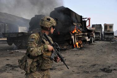 In this 2014 photo, a US soldier investigates the scene of a suicide attack at the Afghan-Pakistan border crossing in Torkham, Nangarhar province. Endless wars in Afghanistan, Syria and Libya, and ongoing conflict in Iraq, have justified the realists' stance against foreign interventions. AFP