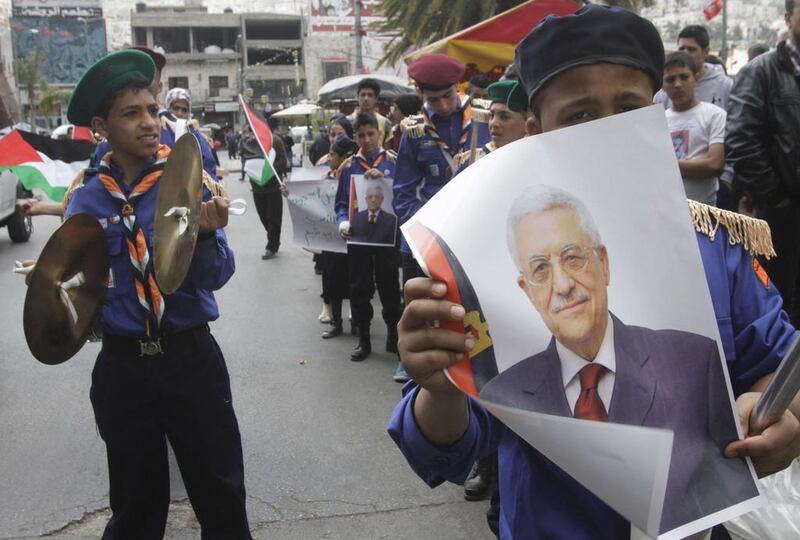 Palestinian scouts hold posters of Mahmoud Abbas during a Fatah rally in support of the Palestinian president in Nablus on April 2, 2014. Abed Omar Qusini / Reuters