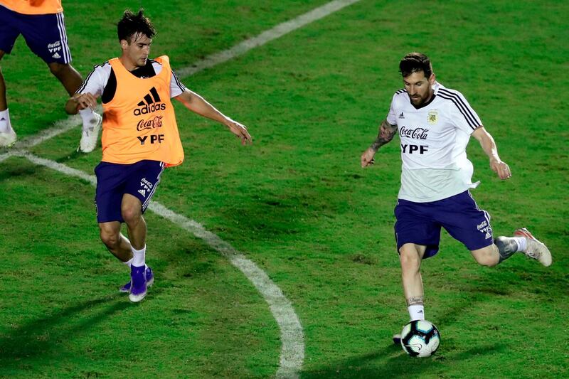 Messi, right, is closed down by teammate Nicolas Tagliafico during training. AFP