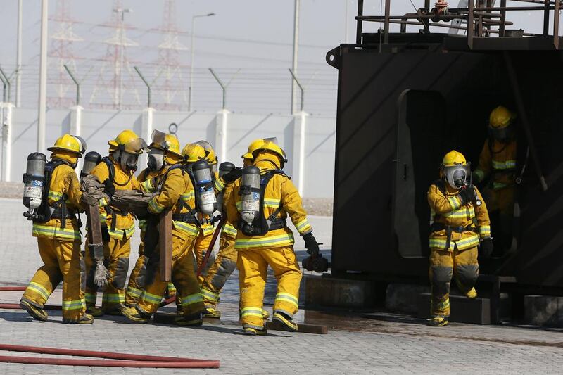 Trainees conduct fire safety drills at the Tawazun Safety Security and Disaster Management City. Pawan Singh / The National