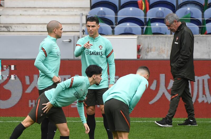 Cristiano Ronaldo talks with defender Pepe as the Portugal squad warms up before their clash with North Macedonia. AFP