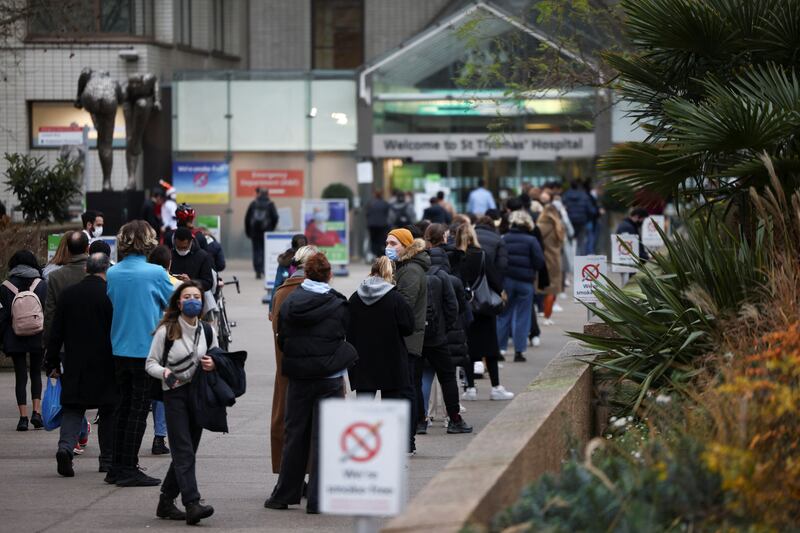 People queue to receive Covid-19 vaccines and booster doses at a walk-in vaccination centre at St. Thomas' Hospital in London. Reuters