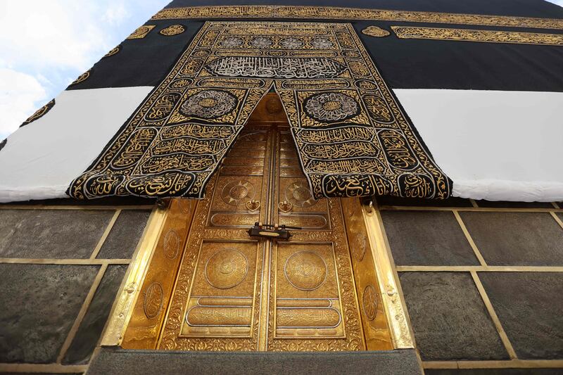 The Kiswa, the cloth used to cover the Kaaba, and the Kaaba's gold doors underneath. The Kiswa is draped every year on the ninth day of Dhu Al Hijjah. AFP