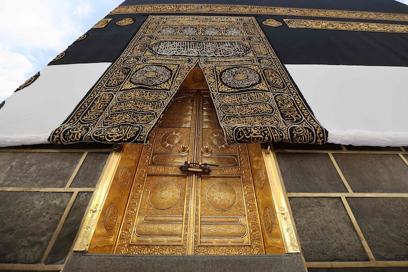 The Kiswa, the cloth used to cover the Kaaba, and the Kaaba's gold doors underneath. The Kiswa is draped every year on the ninth day of Dhu Al Hijjah. AFP