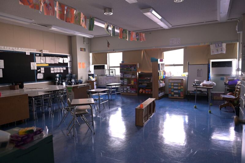 A classroom is empty with the lights off on what would otherwise be a normal school day at Yung Wing School in New York City. AFP