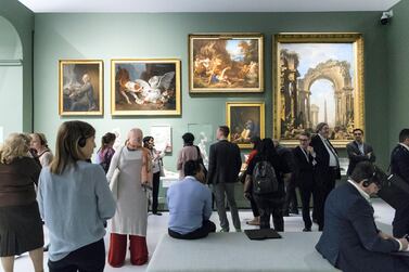 Visitors at an exhibition in Louvre Abu Dhabi. The UAE capital is creating a Dh600 million fund to attract business and leisure events. Christopher Pike / The National