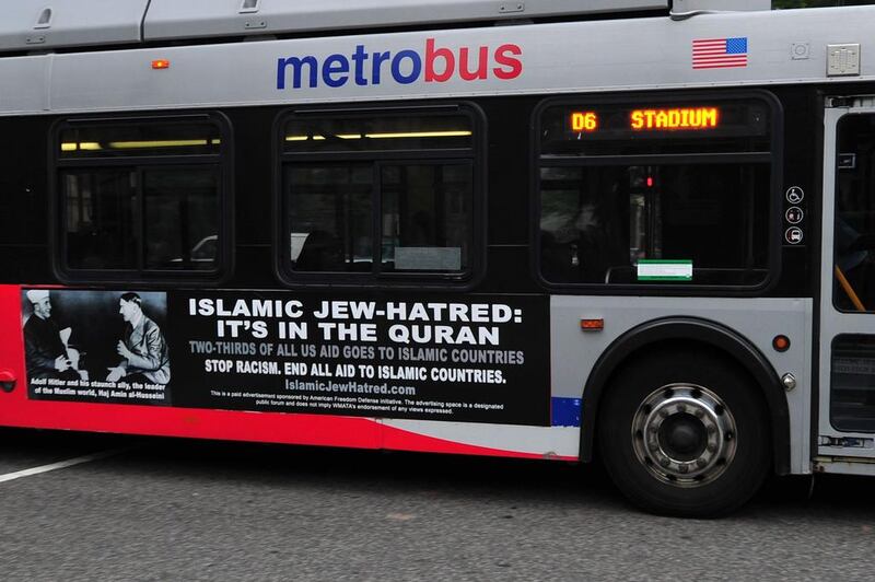 A Metro bus, featuring a controversial ad, drives on a street in Washington, DC on May 21, 2014. Karen Bleir / AFP Photo

