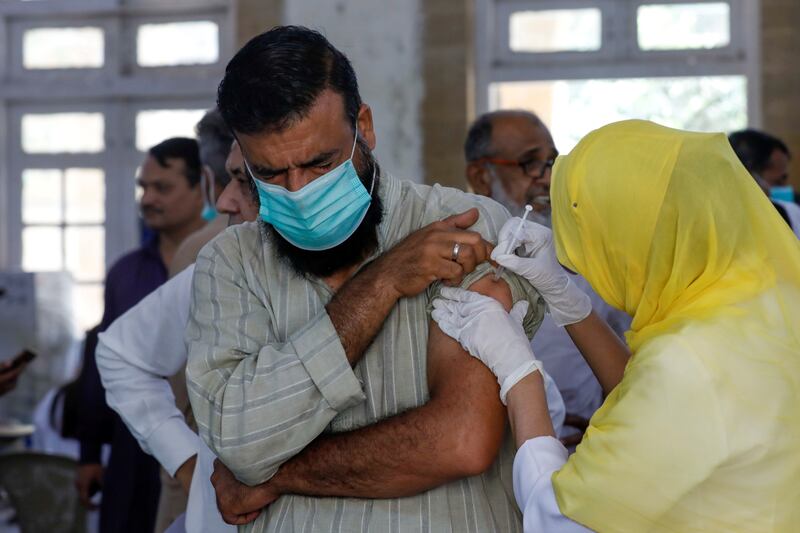 A man receives a vaccine dose in Karachi. Reuters