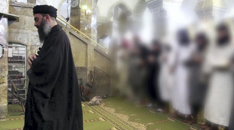 An image grab taken from a propaganda video released on July 5, 2014 by al-Furqan Media allegedly shows the leader of the Islamic State (IS) jihadist group, Abu Bakr al-Baghdadi, aka Caliph Ibrahim, leading prayers next to machine guns with Muslim worshippers behind him, whose picture was blurred from the source, at a mosque in the militant-held northern Iraqi city of Mosul. Baghdadi, who on June 29 proclaimed a "caliphate" straddling Syria and Iraq, purportedly ordered all Muslims to obey him in the video released on social media.    AFP PHOTO / HO / AL-FURQAN MEDIA 
== RESTRICTED TO EDITORIAL USE - MANDATORY CREDIT "AFP PHOTO / HO / AL-FURQAN MEDIA " - NO MARKETING NO ADVERTISING CAMPAIGNS - DISTRIBUTED AS A SERVICE TO CLIENTS FROM ALTERNATIVE SOURCES, AFP IS NOT RESPONSIBLE FOR ANY DIGITAL ALTERATIONS TO THE PICTURE'S EDITORIAL CONTENT, DATE AND LOCATION WHICH CANNOT BE INDEPENDENTLY VERIFIED == (Photo by - / AL-FURQAN MEDIA / AFP)