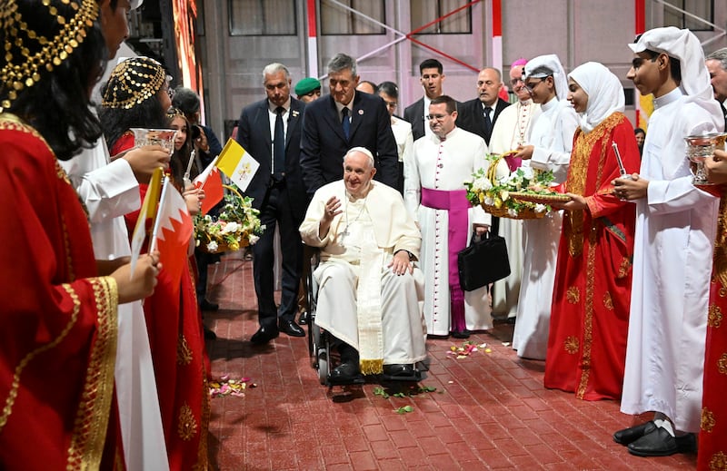 Pope Francis is welcomed by girls and boys in traditional dress during a meeting with young people in Sacred Heart School in Manama, Bahrain. EPA