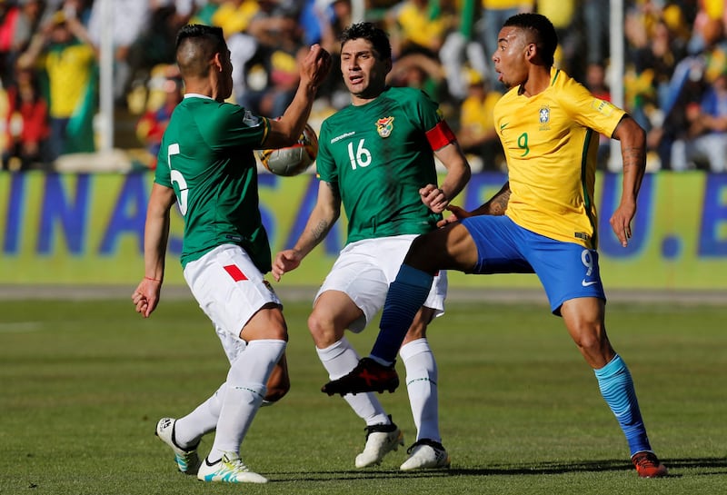 Brazil striker Gabriel Jesus vies for the ball with Luis Gutierrez and Ronald Raldes of Bolivia. David Mercado / Reuters