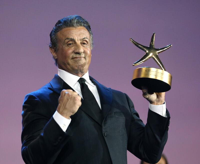 American actor and director Sylvester Stallone poses with his Career Achievement Award at the El Gouna film festival on the Red Sea in Egypt. AFP