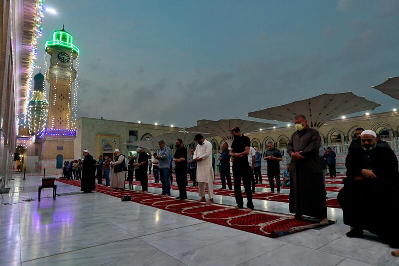 Muslims perform evening prayer at the Sunni shrine of Abdul-Qadir al-Gailani ahead of the upcoming Muslim fasting month of Ramadan in Baghdad, Iraq, Saturday, April 10, 2021. Ramadan is the ninth month of the Islamic lunar calendar and the holiest time of the year for Muslims. (AP Photo/Khalid Mohammed)