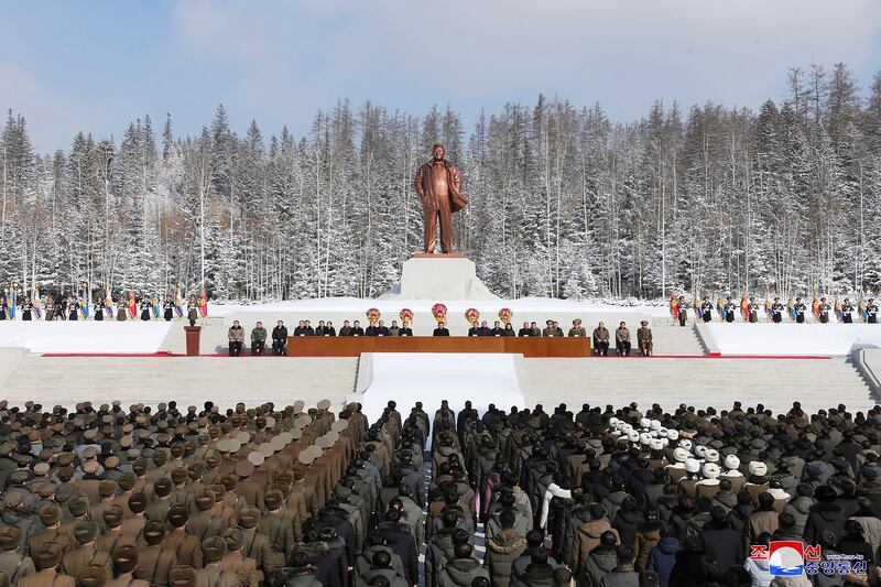 North Korean leader Kim Jong Un (C) attending a national meeting to celebrate the 80th anniversary of the birth of chairman Kim Jong Il, in front of his statue in Samjiyon City, North Korea. AFP