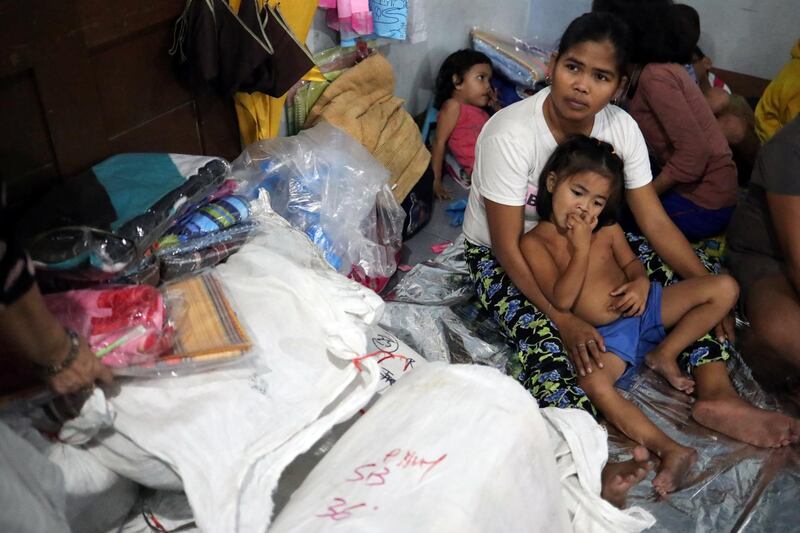 A family gathers at Delpan Evacuation Center after Typhoon Kammuri hit Metro Manila, Philippines. Reuters